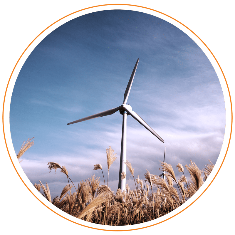 Wind turbine with blue sky and dry grass around it