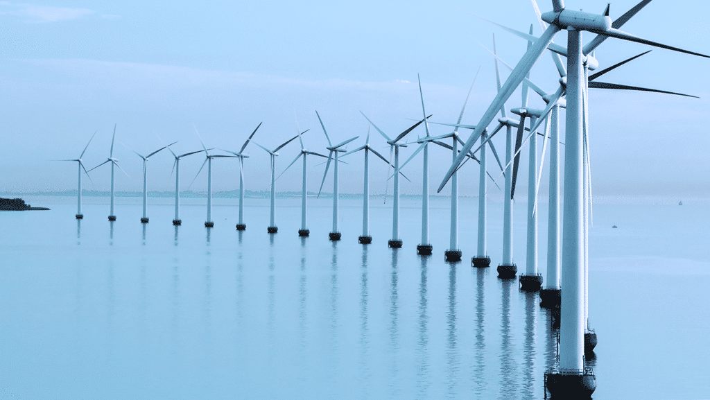 Wind turbines in the ocean with cloudy sky